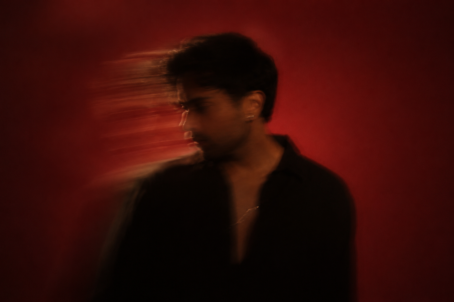 Jafar Khan in a red motion-blur portrait